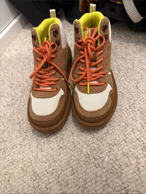 UGG women’s Brown and White High-Top Sneakers with Orange Laces